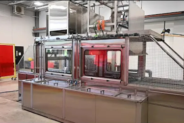 Industrial machine utilizing reusable packaging in a modern facility.