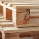 Close-up image of stacked wooden pallets for reusable packaging and transportation.