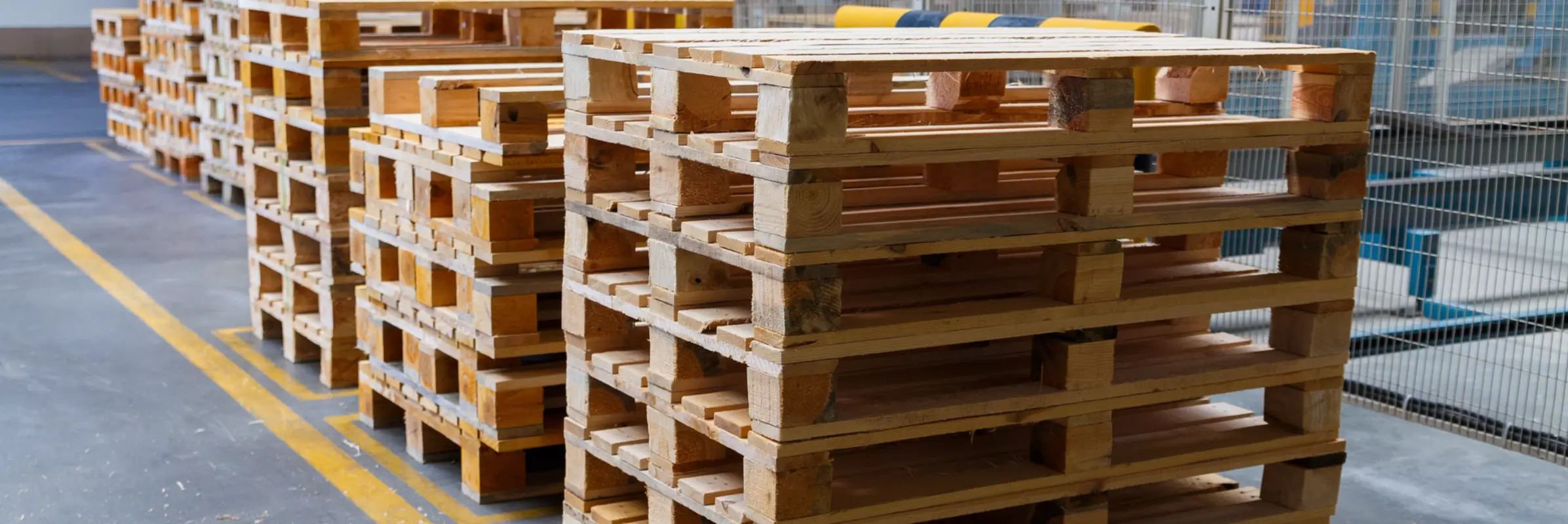 Close-up image of stacked wooden pallets for reusable packaging and transportation.