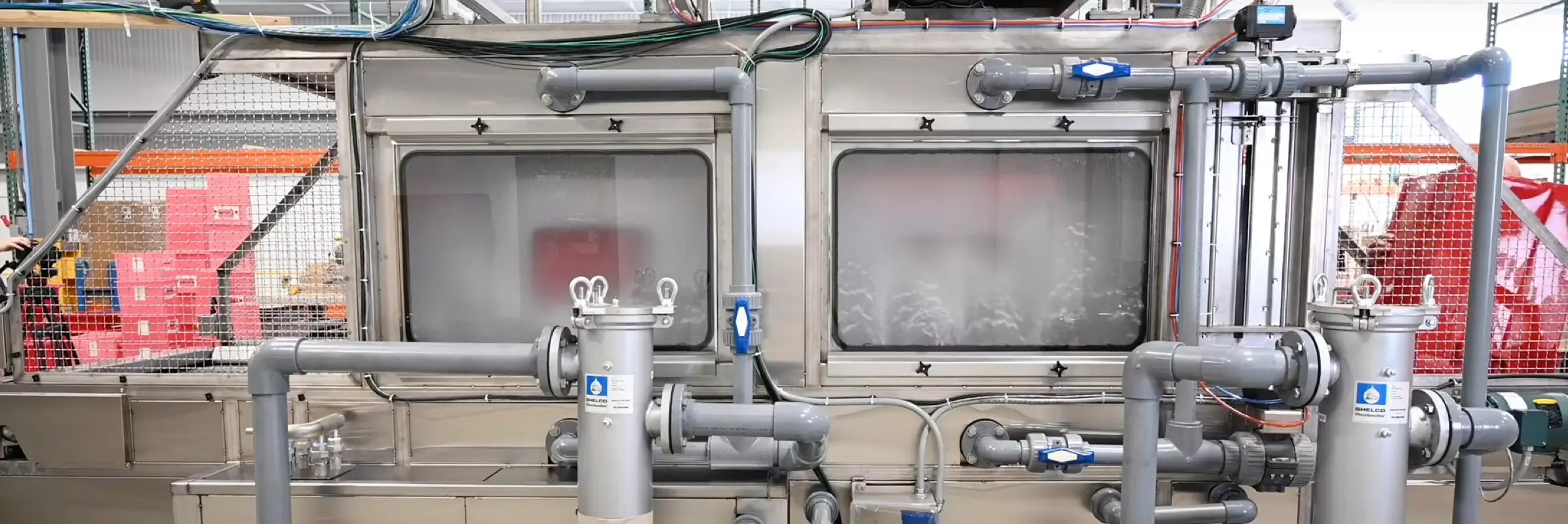 Side view of an automatic industrial washer.