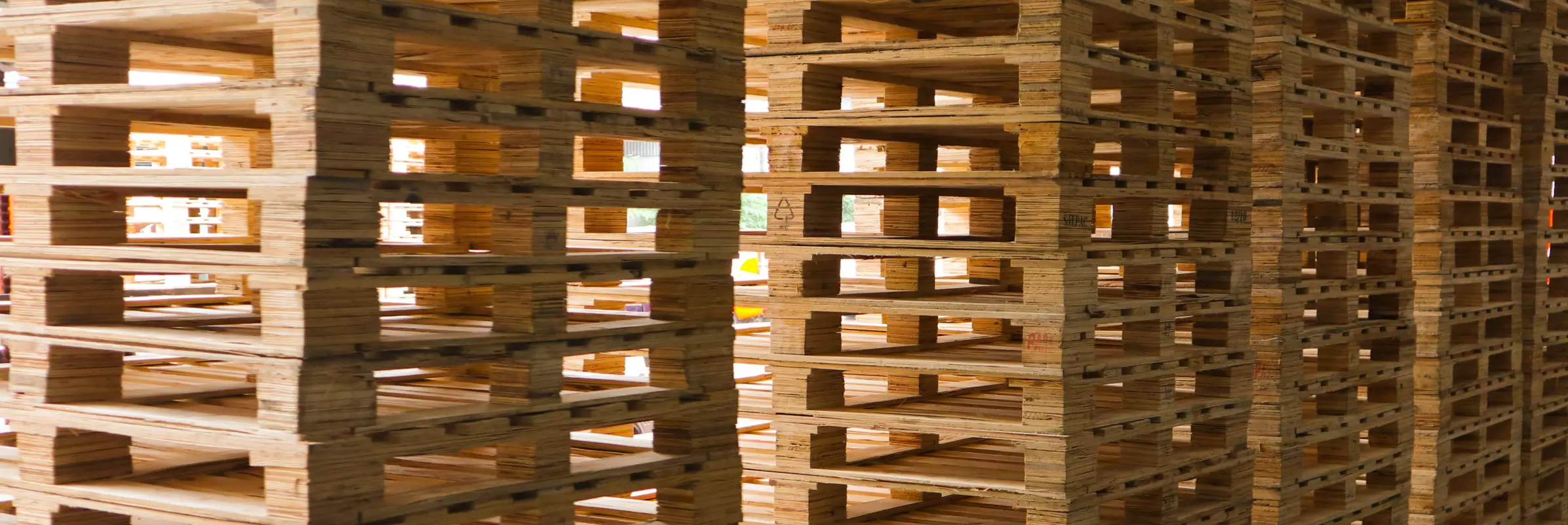 Wooden pallets are stacked at the freight cargo warehouse for transportation.