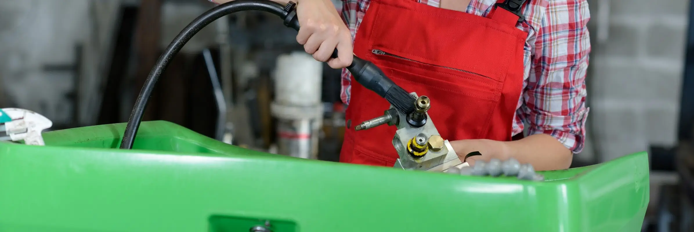 A solvent being used in an industrial parts washer system.